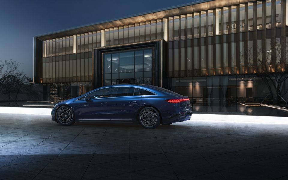 Mercedes-Benz EQS sedan parked in front of a building at night