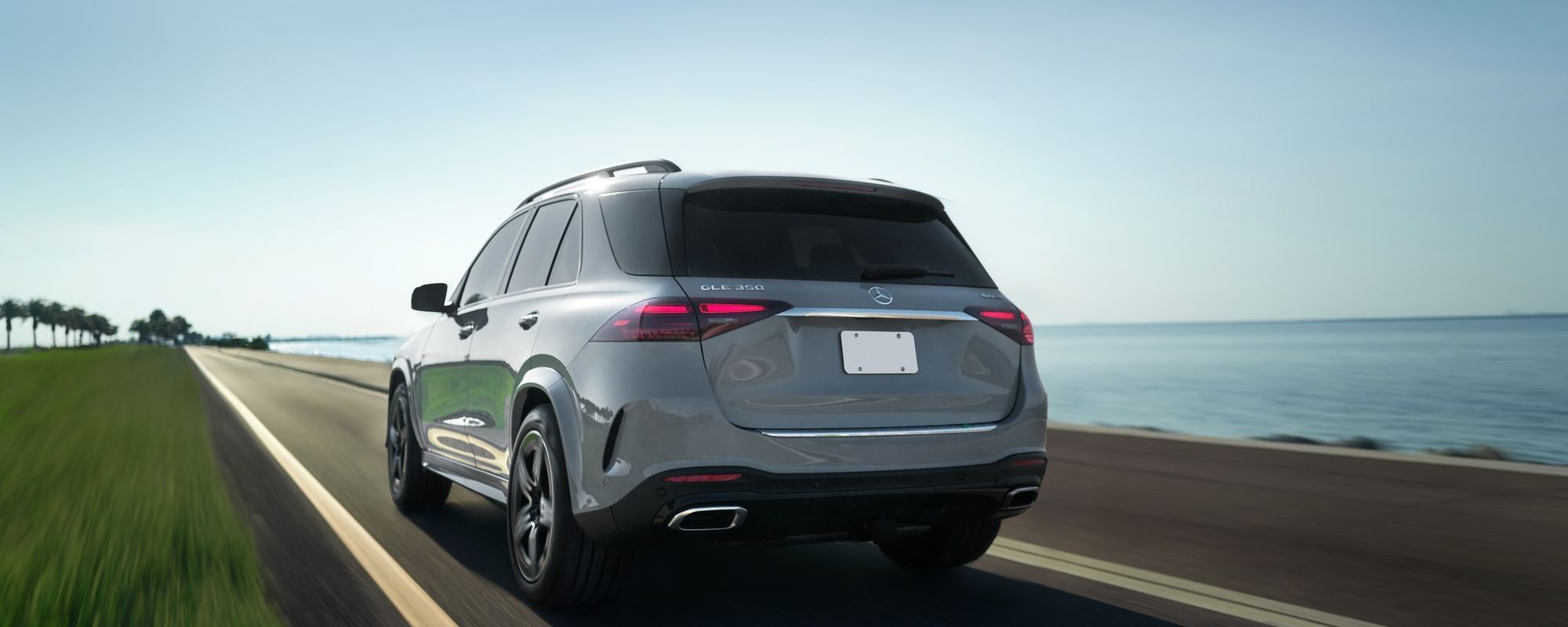 Alpine Grey Mercedes-Benz GLE 350 4MATIC SUV driving along a coastal road